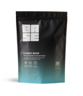 A stand-up resealable pouch of BASE Classic Base Whey Protein Concentrate. The packaging is matte black with a teal gradient at the bottom and features the BASE logo in white at the top.