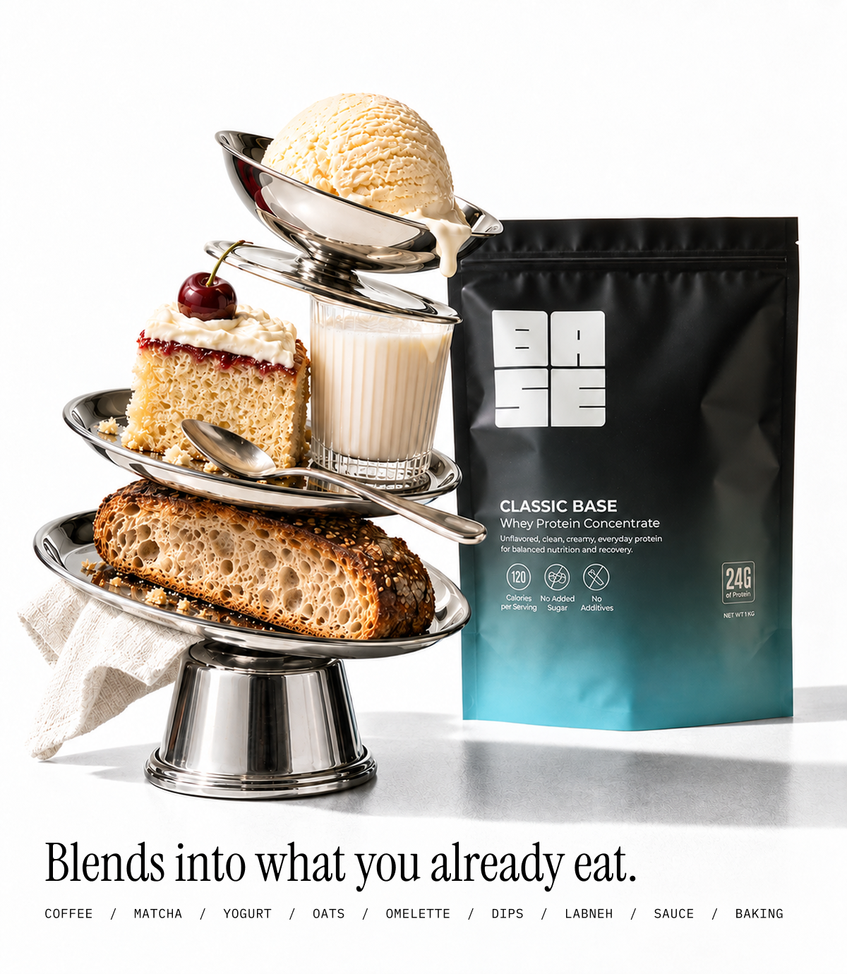 A stand-up pouch of BASE Classic Base protein powder stands beside a three-tiered silver cake stand holding dessert items, including a slice of cake, a glass of milk, a scoop of vanilla ice cream, and a loaf of bread, on a white studio background with marketing text at the bottom.