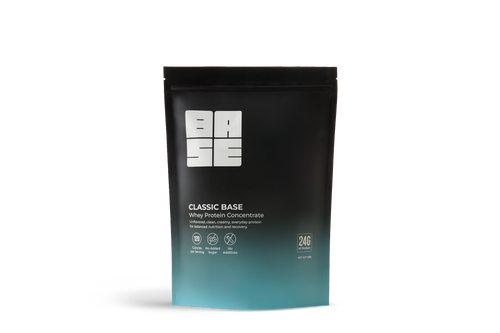 Black protein powder package with 'Base' branding on a white background