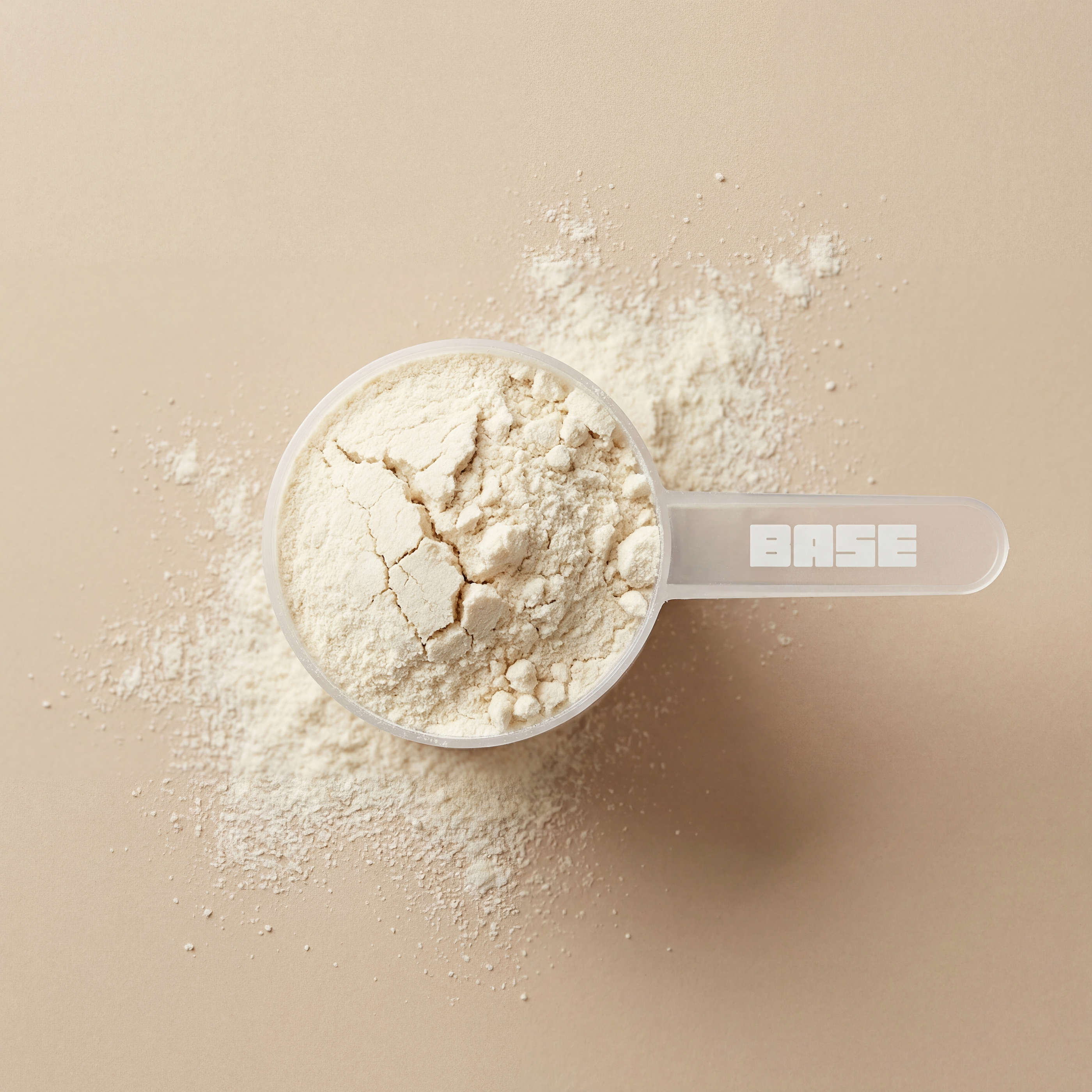 White powder in a clear measuring spoon on a beige background
