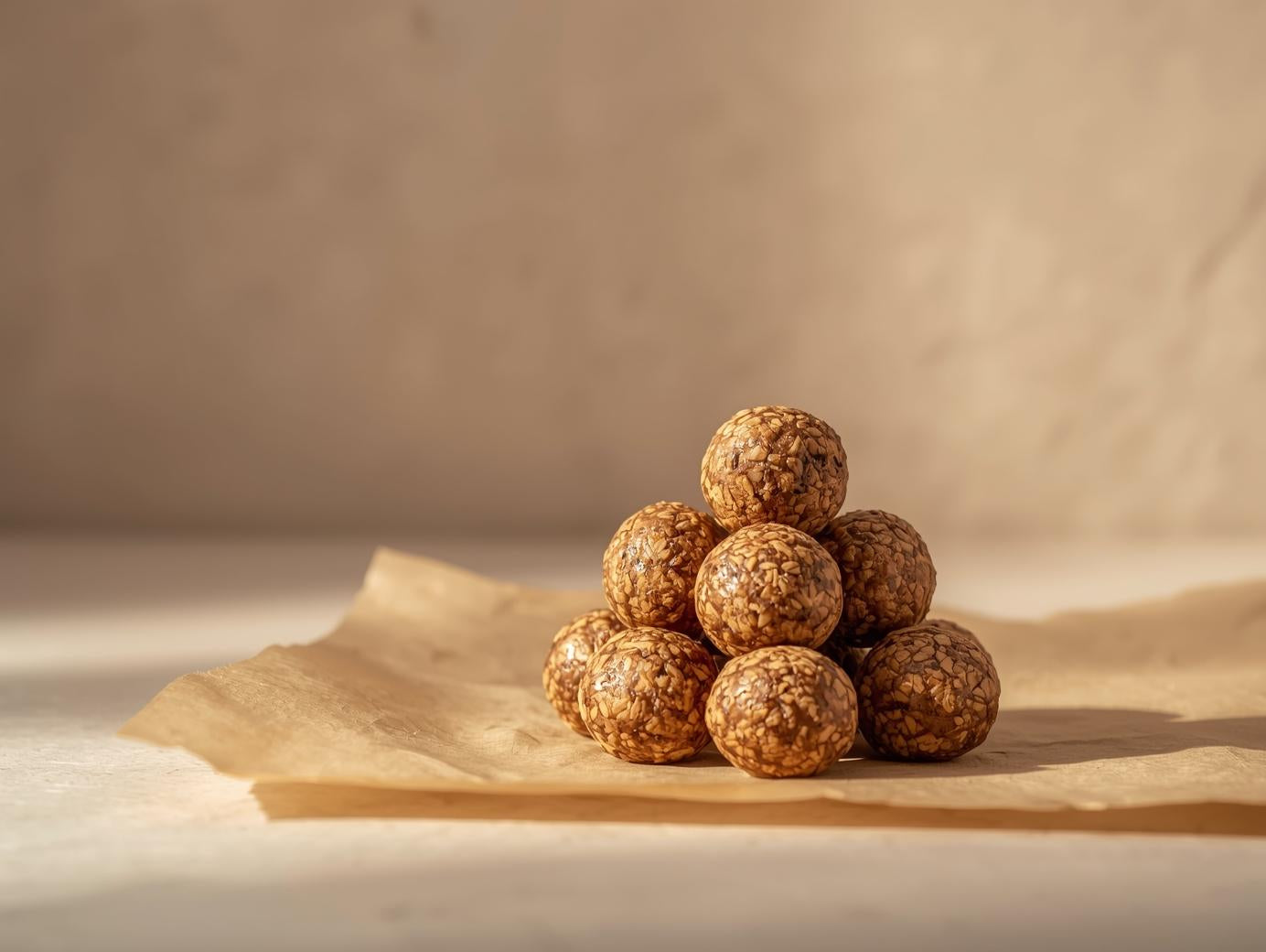 Stack of round brown food items on a beige surface with a neutral background