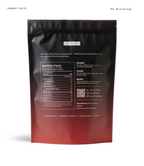 The back of a resealable stand-up pouch package shown on a white background, with product facts, nutrition label, QR code, and usage text visible. The pouch is matte black with a warm orange-to-red gradient concentrated toward the bottom.