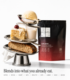 A stand-up pouch of BASE Pure Base White Flavour Blend stands beside a styled dessert tower on a silver tiered stand, with a scoop of vanilla ice cream, cake, milk, bread, and a cherry on a white studio background. Text at the bottom reads, 'Blends into what you already eat.