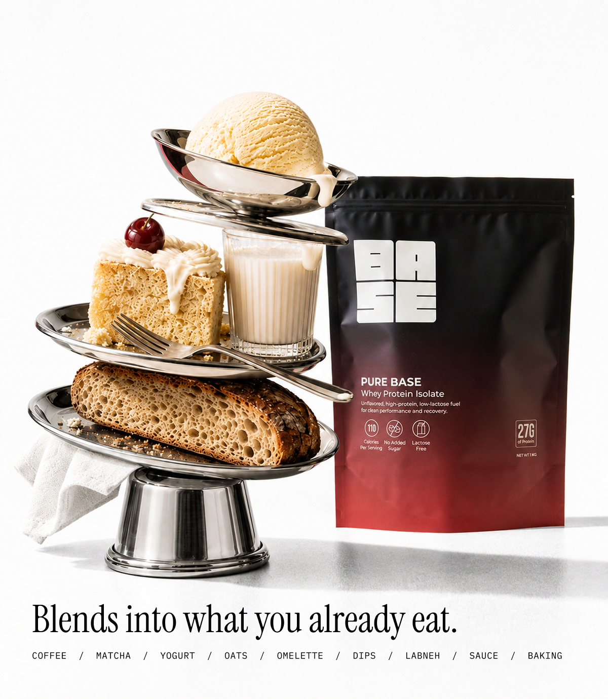 A stand-up pouch of BASE Pure Base White Flavour Blend stands beside a styled dessert tower on a silver tiered stand, with a scoop of vanilla ice cream, cake, milk, bread, and a cherry on a white studio background. Text at the bottom reads, 'Blends into what you already eat.